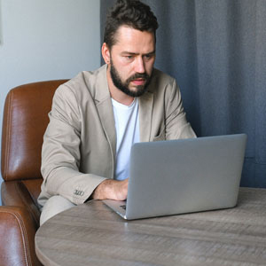 Struggling Online Entrepreneur Working on His Laptop